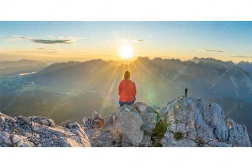 Blick übers Obere Isartal in den Sonnenaufgang im Karwendel - Sonnenanbeter - Seitenverhältnis 2:1 - Bergsteiger auf der Wettersteinspitze - weitere Infos unter https://www.kriner-weiermann.de