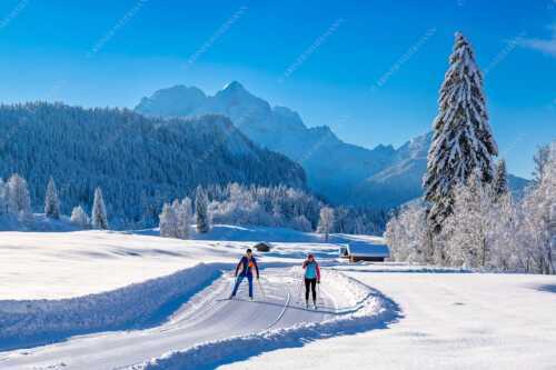Zwei Langläufer genießen die perfekten Schneeverhältnisse im Elmauer Tal - Zwei Stile - ein Ziel - Seitenverhältnis 3:2 - Langlaufen in Elmau - weitere Infos unter https://www.kriner-weiermann.de